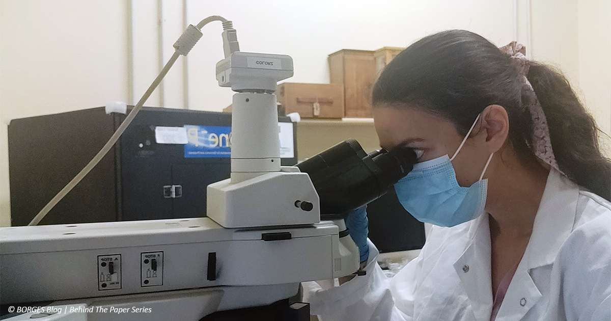Early stage researcher Deniz inspecting the microfluidic device under optical microscope